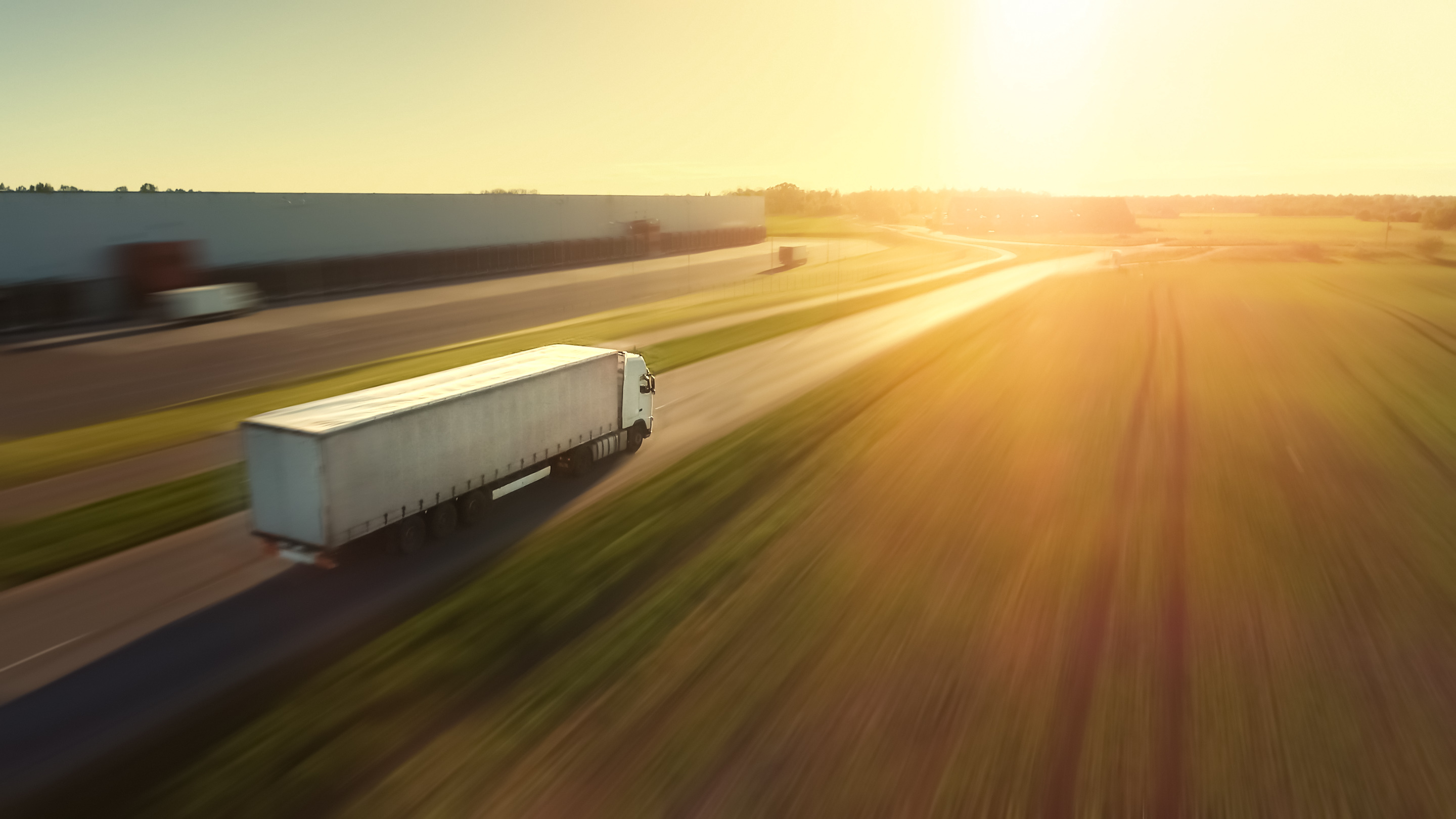 Shipping truck traveling down highway